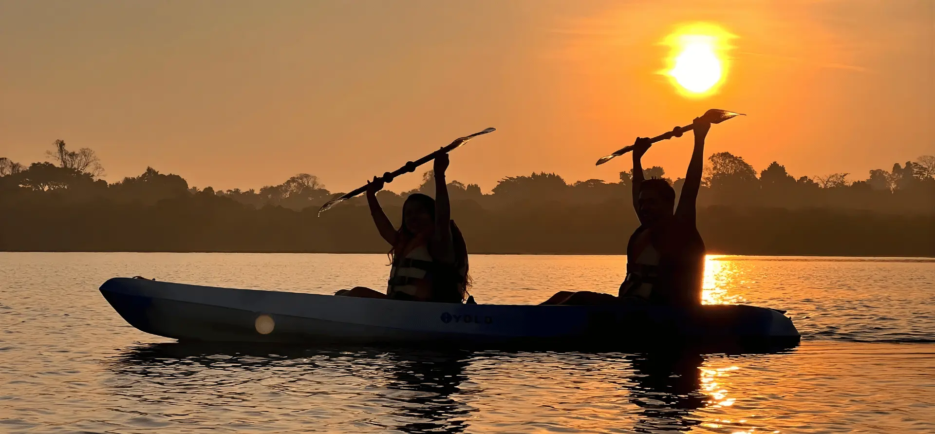 Joyful couple kayaking at sunset in Havelock - unforgettable water sports experience